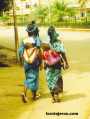 Two African women with their children on their backs  Burkin